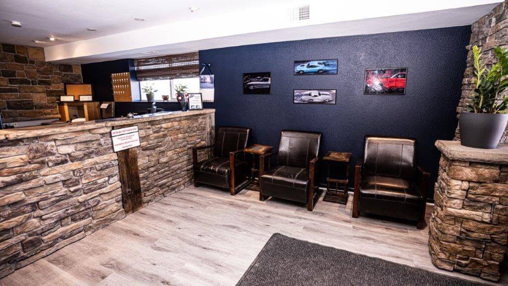 Interior view of Leo's Auto Body front desk and customer waiting area with chairs